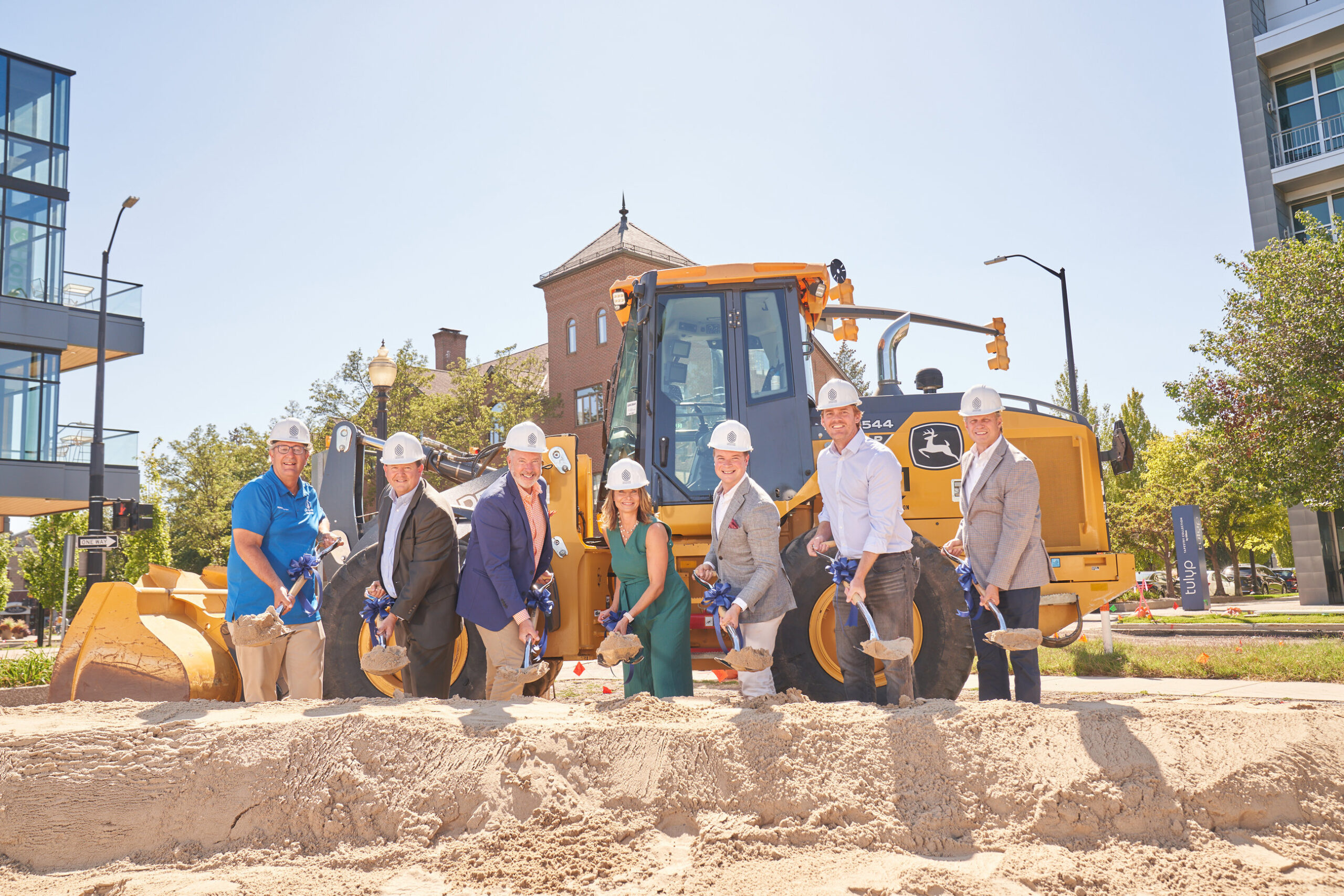 Next Center Groundbreaking Speakers with shovels in front of a piece of heavy equipment 